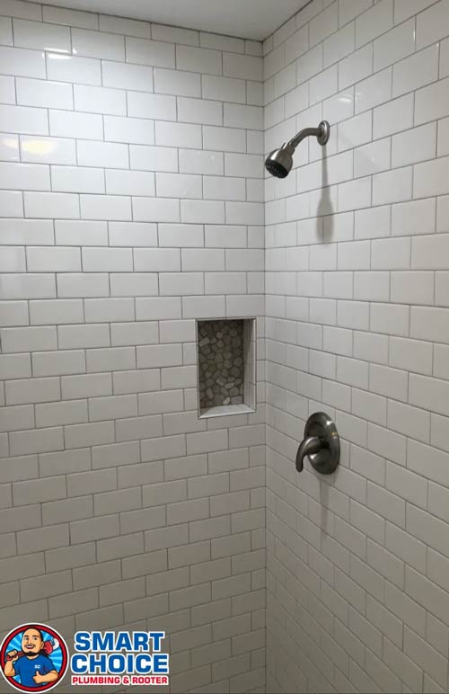 Bathroom shower, with white4 subway tile and brushed sliver fixtures.