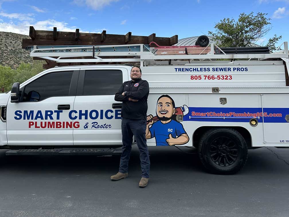 Smart Choice Plumbing owner next his company truck.