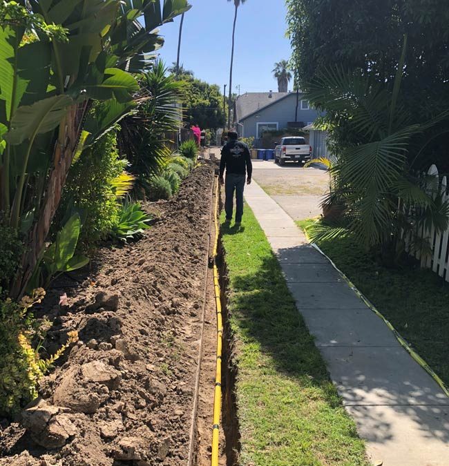 Inspecting underground residential gas line.