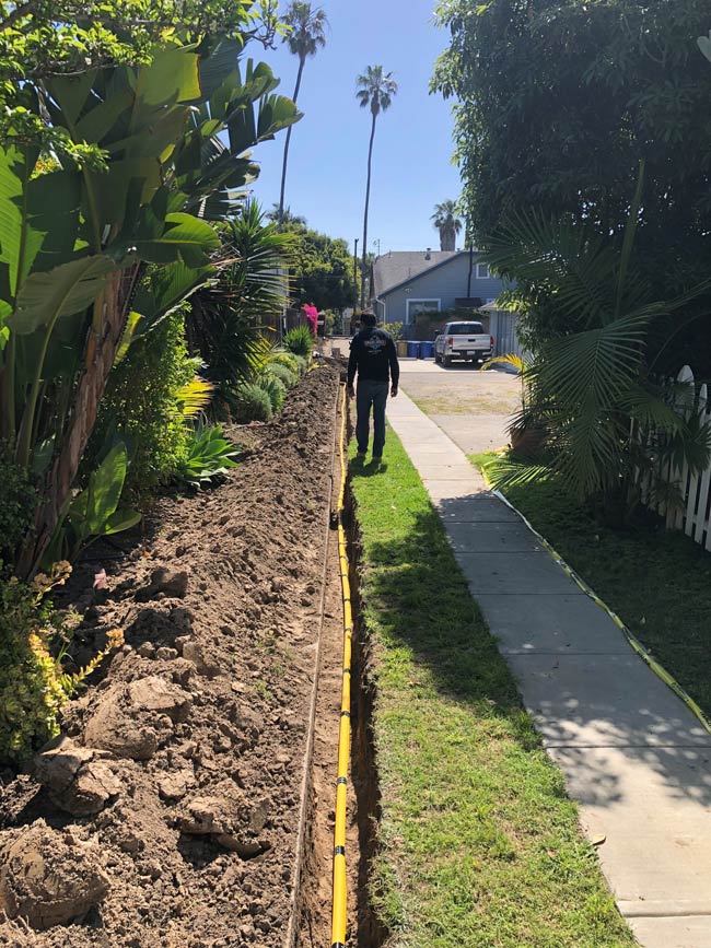 Inspecting underground residential gas line.